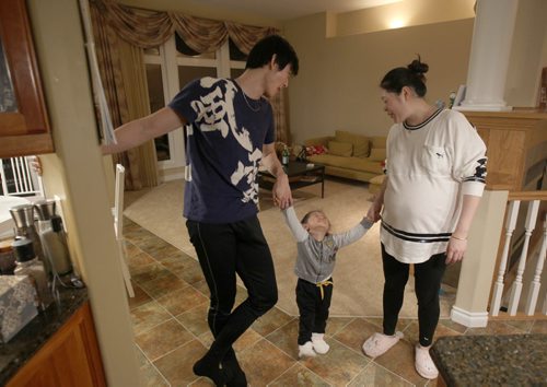 Liang Xing RWB principal male  with his daughter Vivian Xing , 2 yr old  and his expecting wife Ke Hu in his Winnipeg home See Tait,Bryksa,Zoratti feature - Feb, 2015   (JOE BRYKSA / WINNIPEG FREE PRESS)