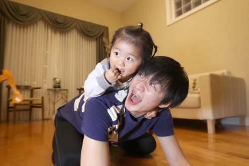 Liang Xing RWB principal male  with his  2 yr old daughter Vivian Xing in his Winnipeg home See Tait,Bryksa,Zoratti feature - Feb, 2015   (JOE BRYKSA / WINNIPEG FREE PRESS)