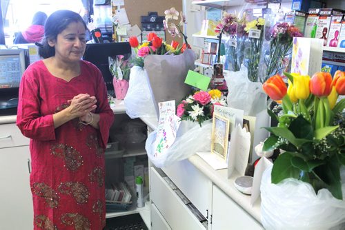 NEWS - Bergie's convenience store in Beausejour. Assault victim Tanu Mukherjee in the store on Monday morning. Here Tanu with some of the many flowers and get well cards from the community. BORIS MINKEVICH/WINNIPEG FREE PRESS MARCH 2, 2015