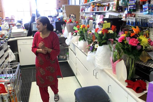 NEWS - Bergie's convenience store in Beausejour. Assault victim Tanu Mukherjee in the store on Monday morning. Here Tanu with some of the many flowers and get well cards from the community. BORIS MINKEVICH/WINNIPEG FREE PRESS MARCH 2, 2015