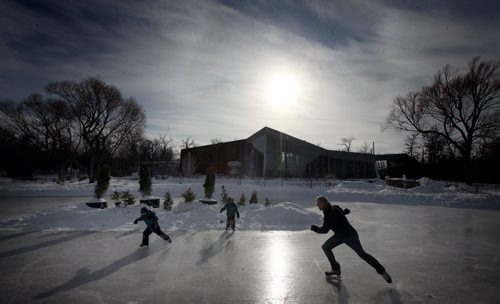 Greg Hanson enjoys an afternoon skate with his sons Erik and Leif at Assinboine Park's duck pond Monday. The trio enjoyed a warm sunny afternoon with the high near -4C. Winnipeg is expecting cloudy cooler temps tomorrow with some snow. March,2 2015 - (Phil Hossack / Winnipeg Free Press)