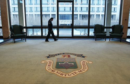 A security guard patrols outside the Mayor's office Tuesday morning. Winnipeg's Mayor Brian Bowman will be presenting his first operating budget today.  150303 March 03, 2015 Mike Deal / Winnipeg Free Press
