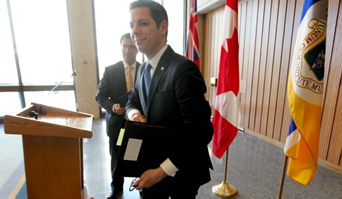 Winnipeg Mayor Brian Bowman is all smiles as he makes his way back to his office  after talking to the press about the new City Budget for 2015 at City Hall Tuesday afternoon.  Tuesday,  March 03, 2015 Ruth Bonneville / Winnipeg Free Press.