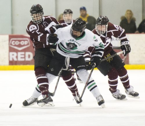150304 Winnipeg - DAVID LIPNOWSKI / WINNIPEG FREE PRESS  St. Paul's Crusaders Evinn Lyonns-Keely (#4) left, and J.P. Lovell (#29) right are tied up with  Vincent Massey Trojans Cole Doherty (#5) in the Winnipeg High School Hockey League Championship game Wednesday March 4, 2015 at MTS Iceplex. St. Paul's dominated the game with a 7-2 victory.