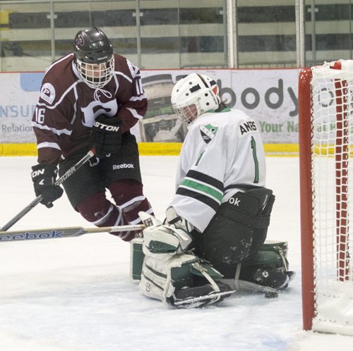 150304 Winnipeg - DAVID LIPNOWSKI / WINNIPEG FREE PRESS  St. Paul's Crusaders Adam Stefanyshyn (#16) scores on Vincent Massey Trojans Jesse Angers (#1) during the Winnipeg High School Hockey League Championship game Wednesday March 4, 2015 at MTS Iceplex. St. Paul's dominated the game with a 7-2 victory.