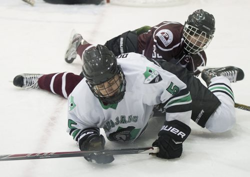 150304 Winnipeg - DAVID LIPNOWSKI / WINNIPEG FREE PRESS  St. Paul's Crusaders  Max Mclean (#33) topples over Vincent Massey Cole Doherty (#5) during the Winnipeg High School Hockey League Championship game Wednesday March 4, 2015 at MTS Iceplex. St. Paul's dominated the game with a 7-2 victory.