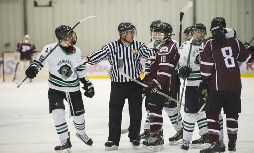 150304 Winnipeg - DAVID LIPNOWSKI / WINNIPEG FREE PRESS  The referee breaks up a fight during the St. Paul's Crusaders and Vincent Massey Trojans  Winnipeg High School Hockey League Championship game Wednesday March 4, 2015 at MTS Iceplex. St. Paul's dominated the game with a 7-2 victory.