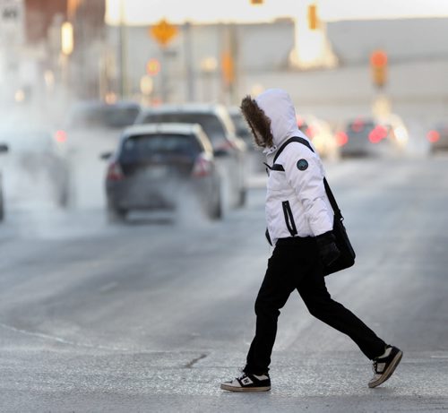 One last cool morning- A pedestrian walks in the cold Thursday morning on York Ave and Smith St. in downtown Winnipeg- South winds will bring Winnipegers relief from the bitter cold coming this weekend - Standup photo- Mar 05, 2015   (JOE BRYKSA / WINNIPEG FREE PRESS)