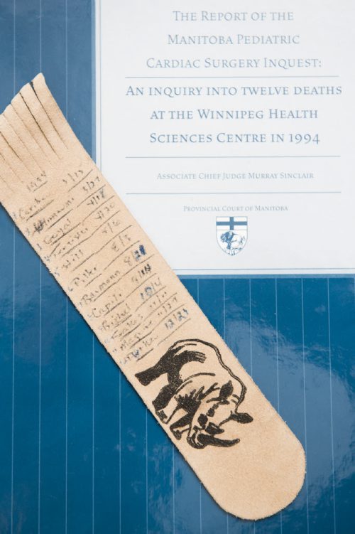 150305 Winnipeg - DAVID LIPNOWSKI / WINNIPEG FREE PRESS  Murray Sinclair, the judge of the Pediatric Cardiac Inquest from the 1990's with the inquest report and a bookmark that he made listing all 12 of the children whose deaths created the baby cardiology inquest.