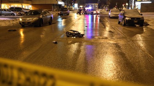 A wheelchair lays in the middle of Marion Street near the Norwood Hotel after a person was struck by a car, Friday, March 6, 2015. (TREVOR HAGAN/WINNIPEG FREE PRESS)