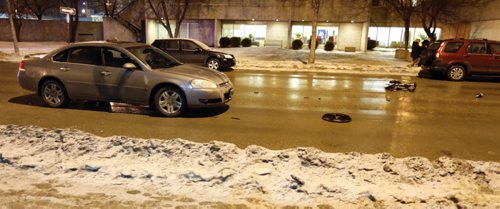 Police investigating and a  wheelchair laying in the middle of Marion Street near the Norwood Hotel after a person was struck by a car, Friday, March 6, 2015. (TREVOR HAGAN/WINNIPEG FREE PRESS)
