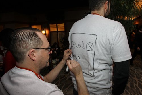 Jean Guy Bourgeois adds to delegate Jesse Hajer's t-shirt sunday morning at the NDP Convention at Canad Inns Polo Park. 150308 - Sunday, March 08, 2015 -  (MIKE DEAL / WINNIPEG FREE PRESS)