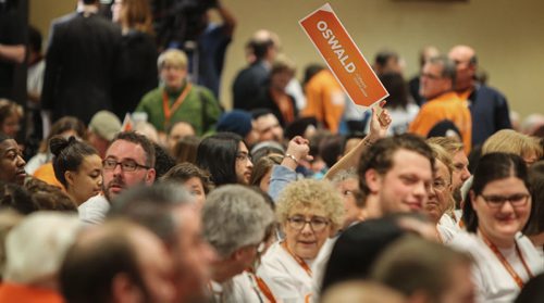 A delegate waves a sign from their seat sunday morning at the start of the last day of the NDP Convention at Canad Inns Polo Park. 150308 - Sunday, March 08, 2015 -  (MIKE DEAL / WINNIPEG FREE PRESS)