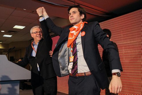 Greg Selinger smiles at his son, Pascal Toupin-Selinger who proudly holds up his fathers hand after winning his re-election as the leader of the provincial NDP on sunday at the NDP Convention at Canad Inns Polo Park. 150308 - Sunday, March 08, 2015 -  (MIKE DEAL / WINNIPEG FREE PRESS)