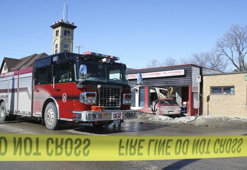 Fire and police crews attended to an unfortunate crash outside Myrnas Café & Catering on Sunday morning. An inattentive driver swerved into the front of the popular Filipino restaurant on Sargent Avenue. March 8, 2015. Jessica Bothelo-Urbanski / Winnipeg Free Press