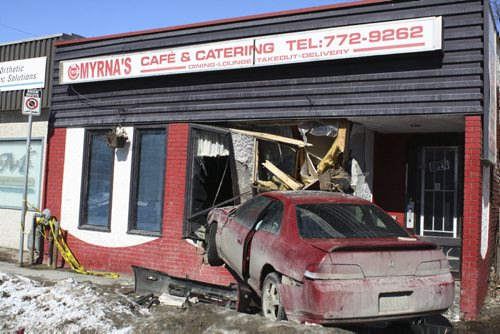 A red Honda Accord drove through Myrnas Café & Catering on Sargent Avenue Sunday morning. Winnipeg police suspect inattentive driving, not alcohol or impairment, was the cause of the crash. March 8, 2015. Jessica Bothelo-Urbanski / Winnipeg Free Press