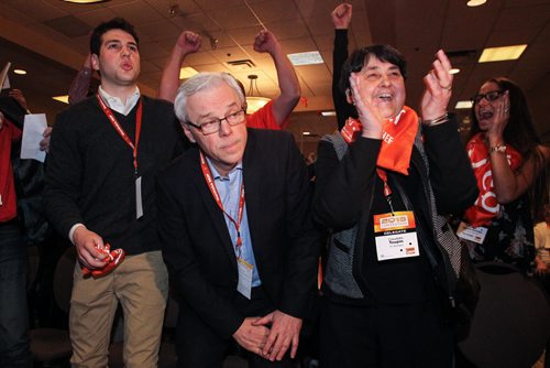 Greg Selinger with a look of relief stands up while his wife Claudette Toupin (right) celebrates his re-election as the leader of the provincial NDP on sunday at the NDP Convention at Canad Inns Polo Park. 150308 - Sunday, March 08, 2015 -  (MIKE DEAL / WINNIPEG FREE PRESS)