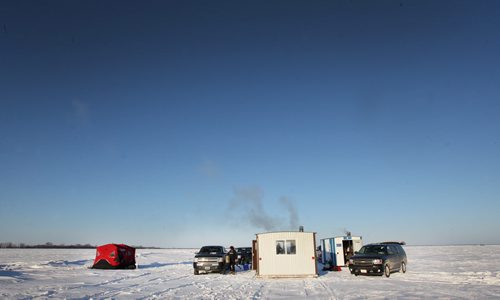 Ice fishing huts stoves are warmed up at first light on Lake Winnipeg aprx 45 km north of Winnipeg- - see Mellisa Tait/Bryksa ice fishing feature story  Apr, 2015   (JOE BRYKSA / WINNIPEG FREE PRESS)