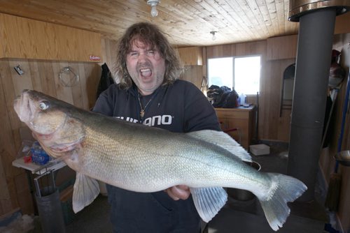 Fishing guide Todd Longley  displays his massive 30 inch walleye he caught while ice fishing  on Lake Winnipeg aprx 45 km north of Winnipeg- The fish was released back into the lake unharmed- seeMellisa Tait/Bryksa ice fishing feature story  Apr, 2015   (JOE BRYKSA / WINNIPEG FREE PRESS)