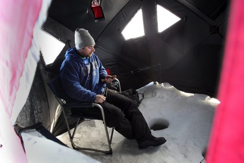 Ian Petremn of  Pelican Lures fishing in his ice hut on  Lake Winnipeg aprx 45 km north of Winnipeg- The fish was released back into the lake unharmed- see Mellisa Tait/Bryksa ice fishing feature story  Apr, 2015   (JOE BRYKSA / WINNIPEG FREE PRESS)