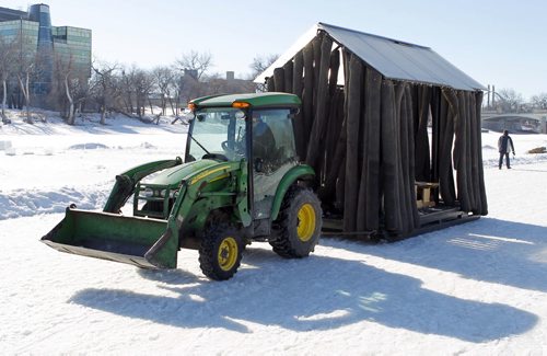 The Red River skating trail is now closed. Today all the warmup shacks were being removed by this green tractor. BORIS MINKEVICH/WINNIPEG FREE PRESS MARCH 9, 2015