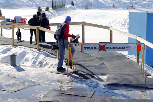 In red jacket and blue hat, Floyd Reichel checks out the closed Red River Trail. He said he wanted to go skating today but is late.  BORIS MINKEVICH/WINNIPEG FREE PRESS MARCH 9, 2015