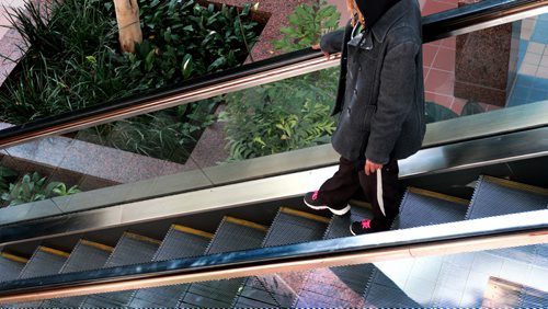 A teenage girl makes her way down the escalator  at Portage Place Mall Tuesday afternoon, See story on malls becoming place for pimps to recruit.   March 10, 2015  / Winnipeg Free Press.