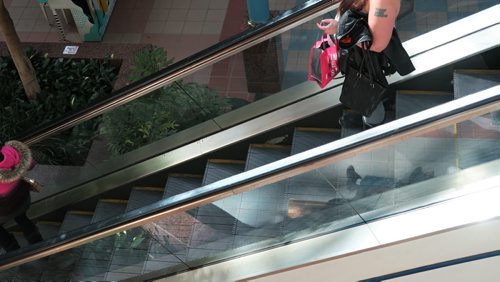 A teenage girl makes her way down the escalator  at Portage Place Mall Tuesday afternoon, See story on malls becoming place for pimps to recruit.   March 10, 2015  / Winnipeg Free Press.