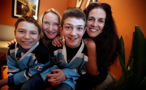 Goalie Joey Goodman, 11 (with his mom Deborah) and the 9 year old Marco Romero (left) (and mom Gaylene) whose making his goalie feel good win or lose has inspired his whole team to do it too. Sinclair story. March 10, 2015 - (Phil Hossack / Winnipeg Free Press)