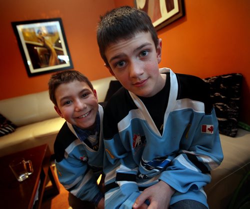 Goalie Joey Goodman, 11 and the 9 year old Marco Romero (left) whose making his goalie feel good win or lose has inspired his whole team to do it too. Sinclair story. March 10, 2015 - (Phil Hossack / Winnipeg Free Press)