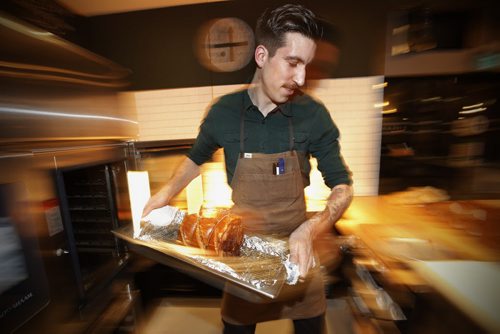 March 10, 2015 - 150310  -  King + Bannatyne chef Tyrone Welchinski prepares a Herb Roast Prochetta in the sandwich shop Tuesday, March 10, 2015. John Woods / Winnipeg Free Press