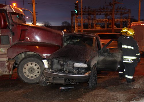 A motorist was lucky with minor injuries after a semi trailer t boned their suv at Notre Dame Ave and King Edward St near 7 AM this morning-Traffic is slow in the area as crews clean up the mess Breaking News- Mar 11, 2015   (JOE BRYKSA / WINNIPEG FREE PRESS)