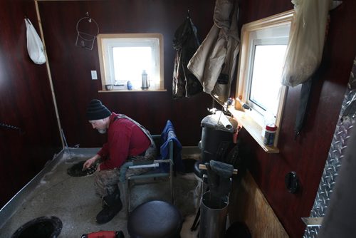 Kenny Wollman in his ice hut on  Lake Winnipeg aprx 45 km north of Winnipeg - see Mellisa Tait/Bryksa ice fishing feature story  Apr, 2015   (JOE BRYKSA / WINNIPEG FREE PRESS)