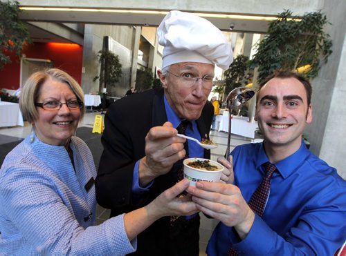 STANDUP - Child Nutrition Council of Manitoba Hosts Third Annual Stone Soup fundraiser- at Manitoba Hydro Place Lobby, 360 Portage Avenue. Soups created and served by some of Winnipegs best chefs. In this photo left to right -Child Nutrition Council of Winnipeg Exec. Dir. Viola Prowse, Winnipeg entertainer Al Simmons, and Inferno's on Academy owner Chris Kirouac pose for a photo with the People Choice winning bowl of soup from Kirouac's restaurant. The soup was Chicken Ragu w/ Cashew Kale Chips. Simmons was a judge. BORIS MINKEVICH/WINNIPEG FREE PRESS MARCH 11, 2015