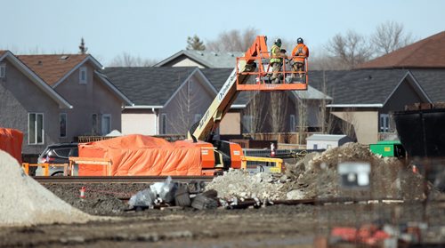 Work on the Plessis Underpass continues next to a line of homes on Paul Martin Drive. See Ashley Prest story. March 11, 2015 - (Phil Hossack / Winnipeg Free Press)