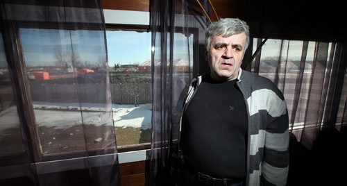 Zeljko Cupic stands in his Paul Martin Drive home overlooking work on the Plessis Underpass next to Paul Martin Drive. See Ashley Prest story. March 11, 2015 - (Phil Hossack / Winnipeg Free Press)