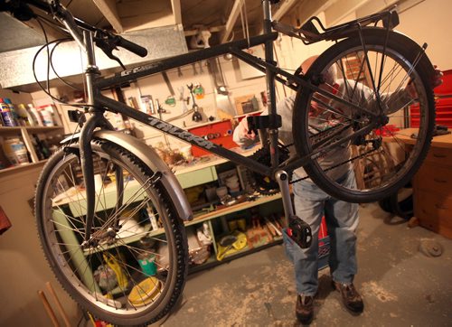 MONEY MAKEOVER - "Howard", forced into early retirement and unsure of his options gets his bike ready for some inexpensive retirement options. See Joel Schlessinger story.  (March 12, 2015 - Phil Hossack / Winnipeg Free Press)