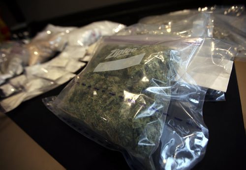 Drugs cash and guns filled display tables at "D" Division headquarters in Winnipeg Friday as officers spoke about Project DARE. See release. March 13, 2015 - (Phil Hossack / Winnipeg Free Press)