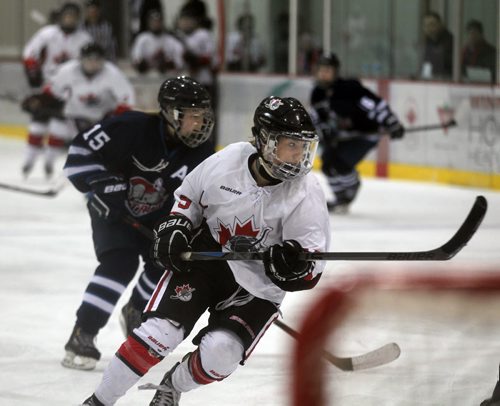 Pursuit of Excellence - Red's" #9 Sarah Potomak wheels past Shaftbury's #15 Hannah Dalrymple Friday Morning at the IcePlex. See story re: Female World Sport School.  March 13, 2015 - (Phil Hossack / Winnipeg Free Press)
