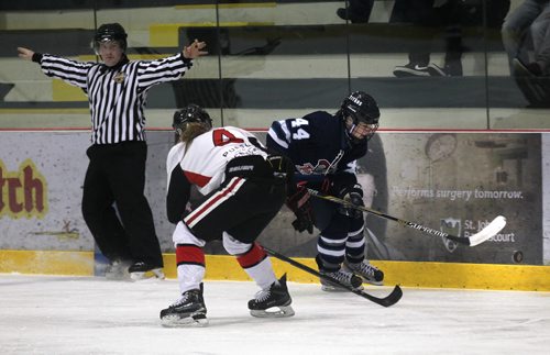 Shaftsbury #44 Savannah Rennie keeps an eye on the bouncing puck as she deeks around Pursuit of Excellence - Red's" $4 Abby Cook's defence Friday Morning at the IcePlex. See story re: Female World Sport School.  March 13, 2015 - (Phil Hossack / Winnipeg Free Press)