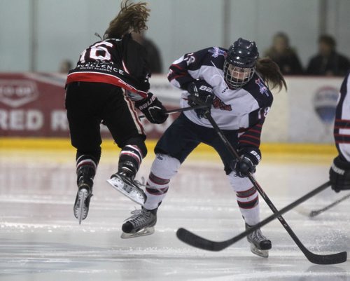 Amy Potomak, #16 with Pursuit of Excellence - Black, clashes mid ice with Kayla Friesen #18 with St. Mary's Academy  as they battle it out in the FWSSChallenge female hockey tournament at Iceplex Friday night.  March 13, 2015 Ruth Bonneville / Winnipeg Free Press.