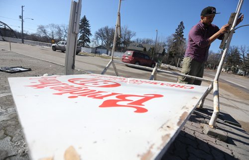 Justin Jacob, one of the owners of the BDI puts up a sign after opening for the season around noon today, Saturday, March 14, 2015. (TREVOR HAGAN/WINNIPEG FREE PRESS)