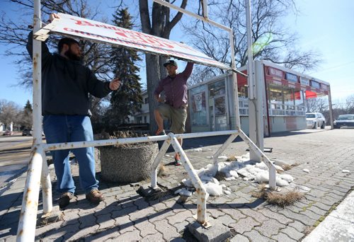 Chad Bragg and Justin Jacob, owners of the BDI putting up a sign after opening for the season around noon today, Saturday, March 14, 2015. (TREVOR HAGAN/WINNIPEG FREE PRESS)