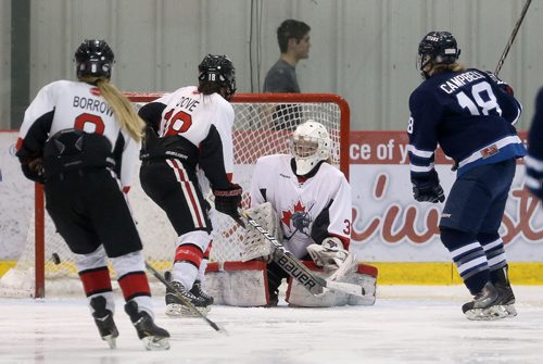 Jessica Campbell of the Shaftesbury Titans tips a shot passed Kate Kowalchuck Persuit of Excellence during their game at the Iceplex, Saturday, March 14, 2015. (TREVOR HAGAN/WINNIPEG FREE PRESS)