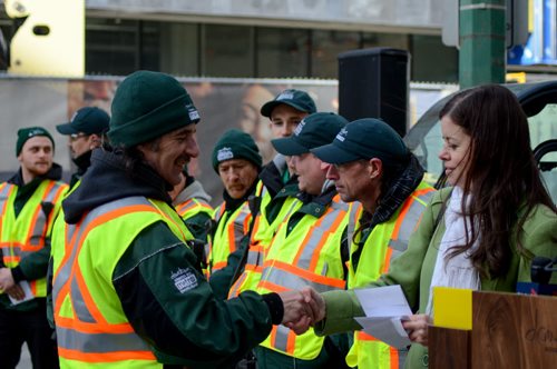 The Metro Enviro-Team workers receive a small "token of appreciation" from Stephanie Voyce, Winnipeg BIZ manager at downtown press conference celebrating Winnipeg's improved downtown cleanliness stats and enhanced services for 2015. Monday, March 16, 2015  - (JENNA DULEWICH/WINNIPEG FREE PRESS)