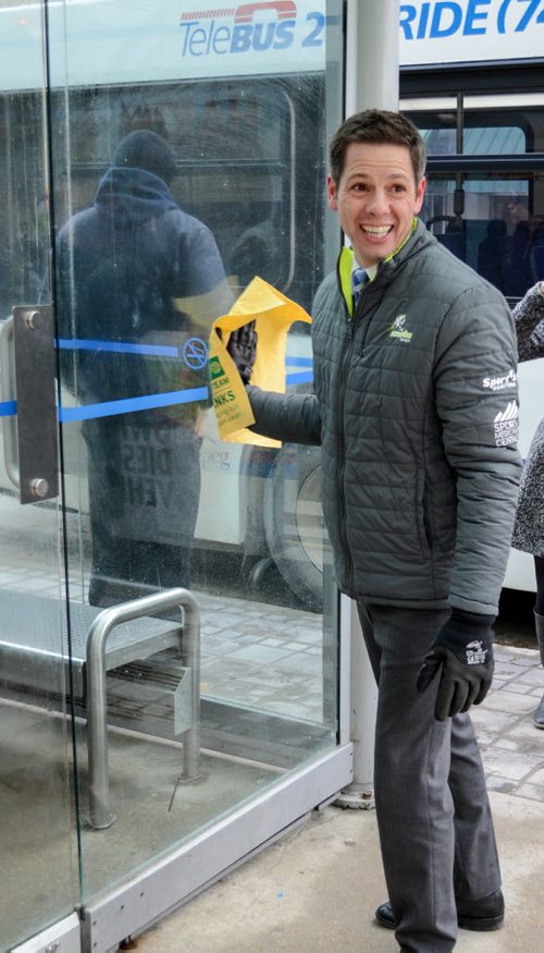 Mayor Brian Bowman cleans downtown bus shelter at press conference celebrating Winnipeg's improved downtown cleanliness stats and enhanced services for 2015. Monday, March 16, 2015  - (JENNA DULEWICH/WINNIPEG FREE PRESS)