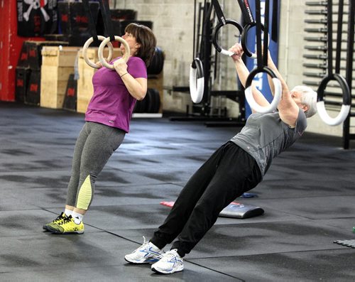 Participants in the Legends program at Crossfit 204 (483 Berry Street) work out Monday. The class is geared toward seniors/older athletes and is taught by Crystal Kirby-Peloquin, who is the manager of Crossfit 204. (L-r) Chris Bowes and Mavis Puchlik.  150316 March 16, 2015 Mike Deal / Winnipeg Free Press