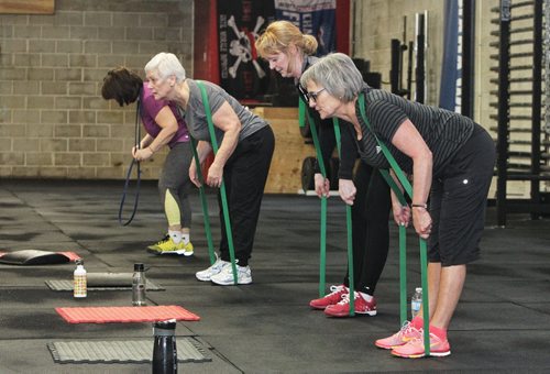 Participants in the Legends program at Crossfit 204 (483 Berry Street) work out Monday. The class is geared toward seniors/older athletes and is taught by Crystal Kirby-Peloquin, who is the manager of Crossfit 204. A light warmup on the rowing machines starts off the session (L-r) Chris Bowes, Mavis Puchlik, Debbie Rodger, and Analyn Baker.  150316 March 16, 2015 Mike Deal / Winnipeg Free Press