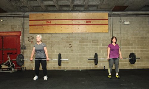 Mavis Puchlik (left) and Chris Bowes (right) participates in the Legends program at Crossfit 204 (483 Berry Street) work out Monday. The class is geared toward seniors/older athletes and is taught by Crystal Kirby-Peloquin, who is the manager of Crossfit 204.  150316 March 16, 2015 Mike Deal / Winnipeg Free Press