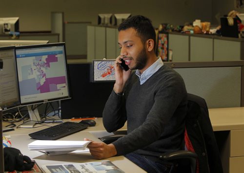 Inayat Singh poses for a photo at his work area in the news room. BORIS MINKEVICH/WINNIPEG FREE PRESS MARCH 16, 2015